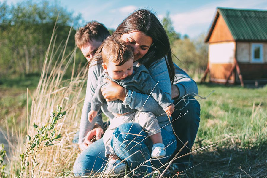 About Our Agency - Mother And Father Showing Their Son The Beauty Of Nature In The Countryside